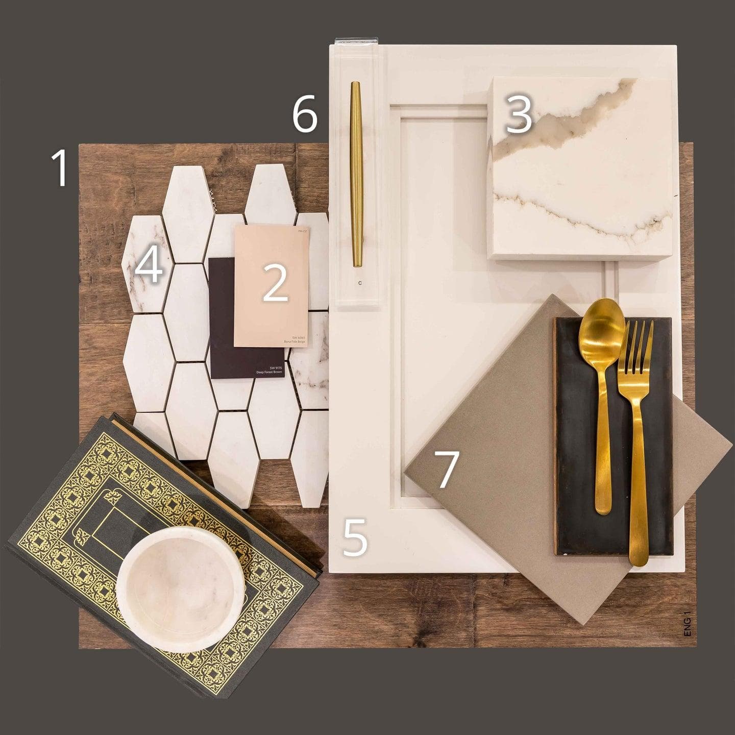 Numbered materials board with wood flooring, marble hex tile, a cabinet door sample, quartz, paint chips and brass hardware